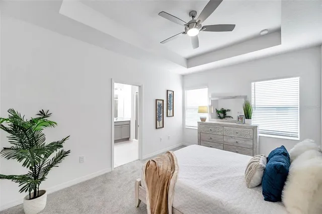 a bedroom with a large bed and a chandelier
