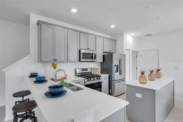 a kitchen with a sink appliances and cabinets