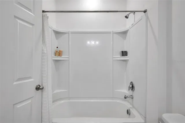 a bathroom with a shower and a tub
