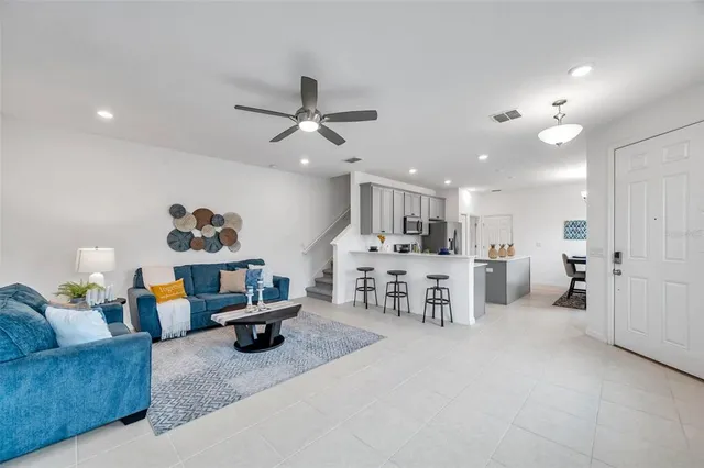 a living room with furniture and kitchen view