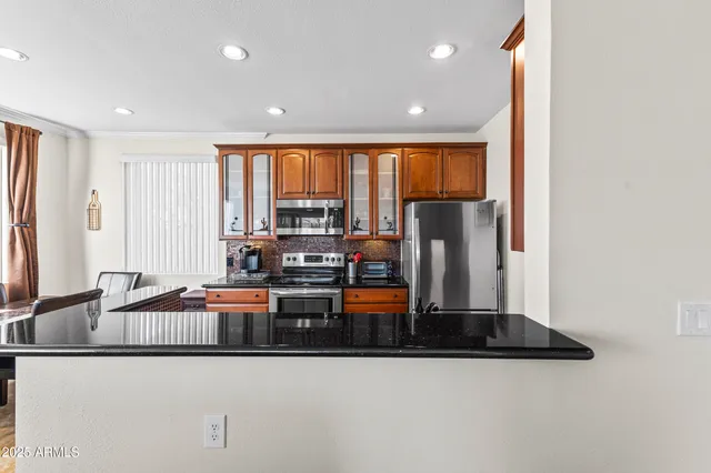 a kitchen with stainless steel appliances granite countertop a stove and a sink