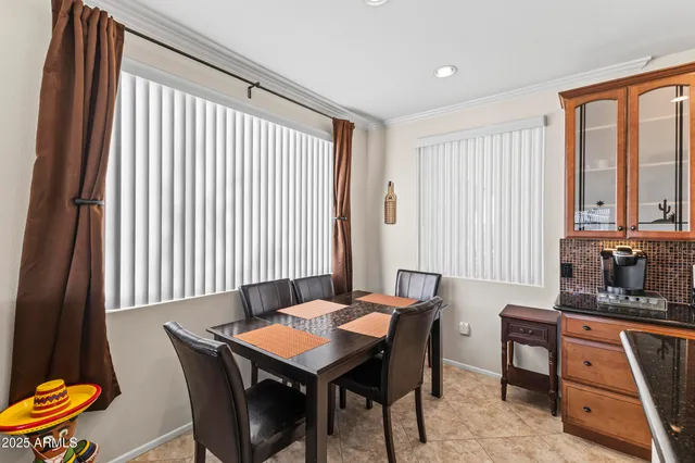 a living room with furniture a fireplace and a large window