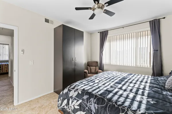 a bedroom with a bed and a lamp