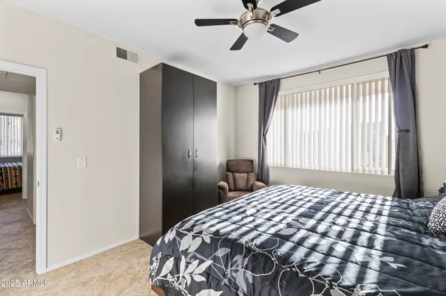 a bedroom with a bed and a lamp