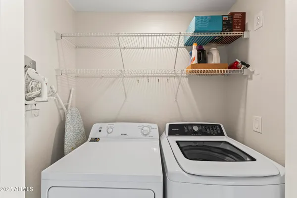a view of a balcony with furniture and a floor to ceiling window
