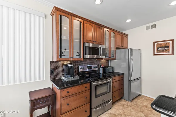 a living room with furniture a fireplace and a large window