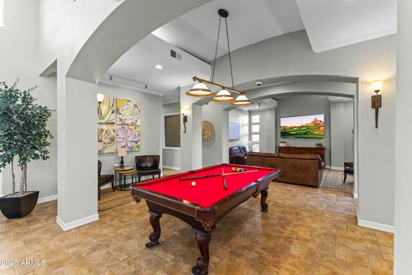 a view of a patio with a table and chairs next to a yard