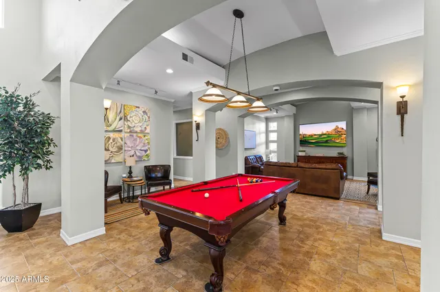 a view of a patio with a table and chairs next to a yard