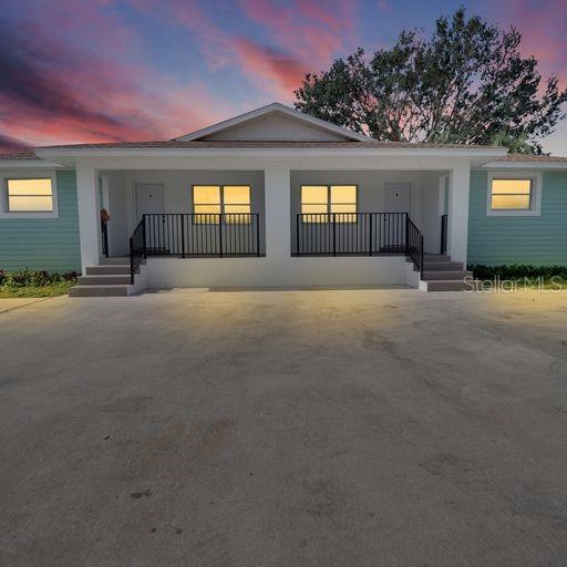a front view of a house with basket ball court and a garage