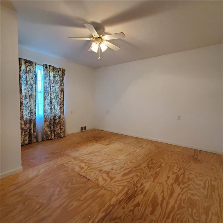 266 Catalpa Road Chicora, PA 16025 - Photo 18 of 23 an empty room with chandelier fan and windows