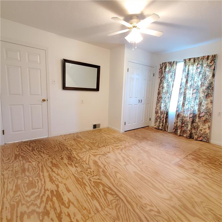266 Catalpa Road Chicora, PA 16025 - Photo 19 of 23 a view of a bedroom with wooden floor and a ceiling fan
