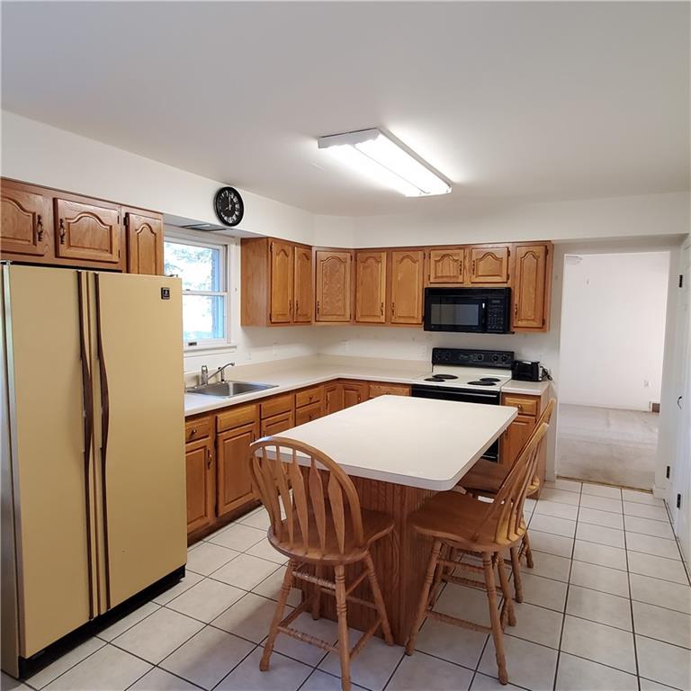 266 Catalpa Road Chicora, PA 16025 - Photo 5 of 23 a kitchen with stainless steel appliances granite countertop a refrigerator a stove a sink a dining table and chairs