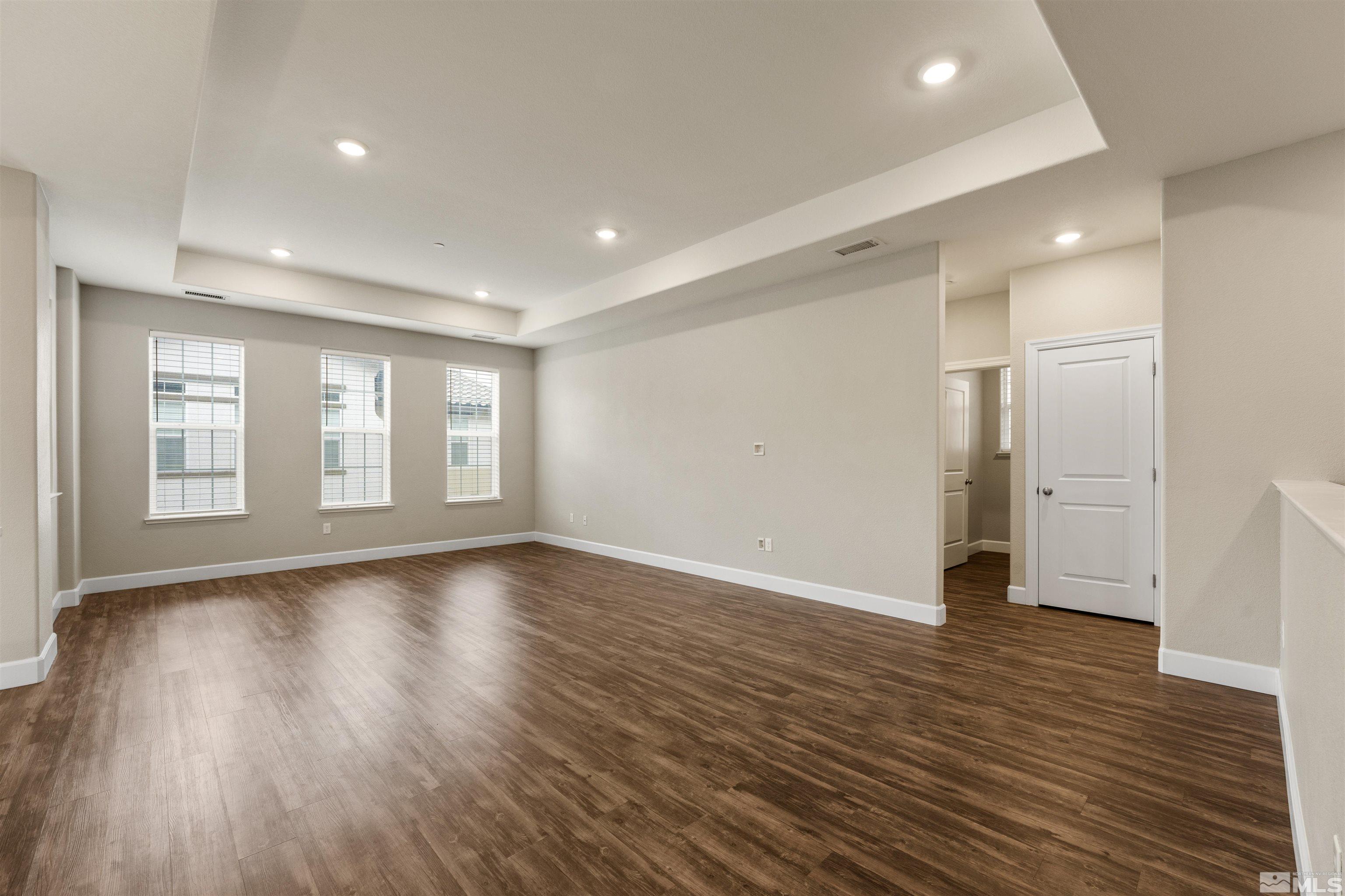 1945 Sea Horse Road, Unit A Reno, NV 89521 - Photo 11 of 25 a view of an empty room with wooden floor and a window