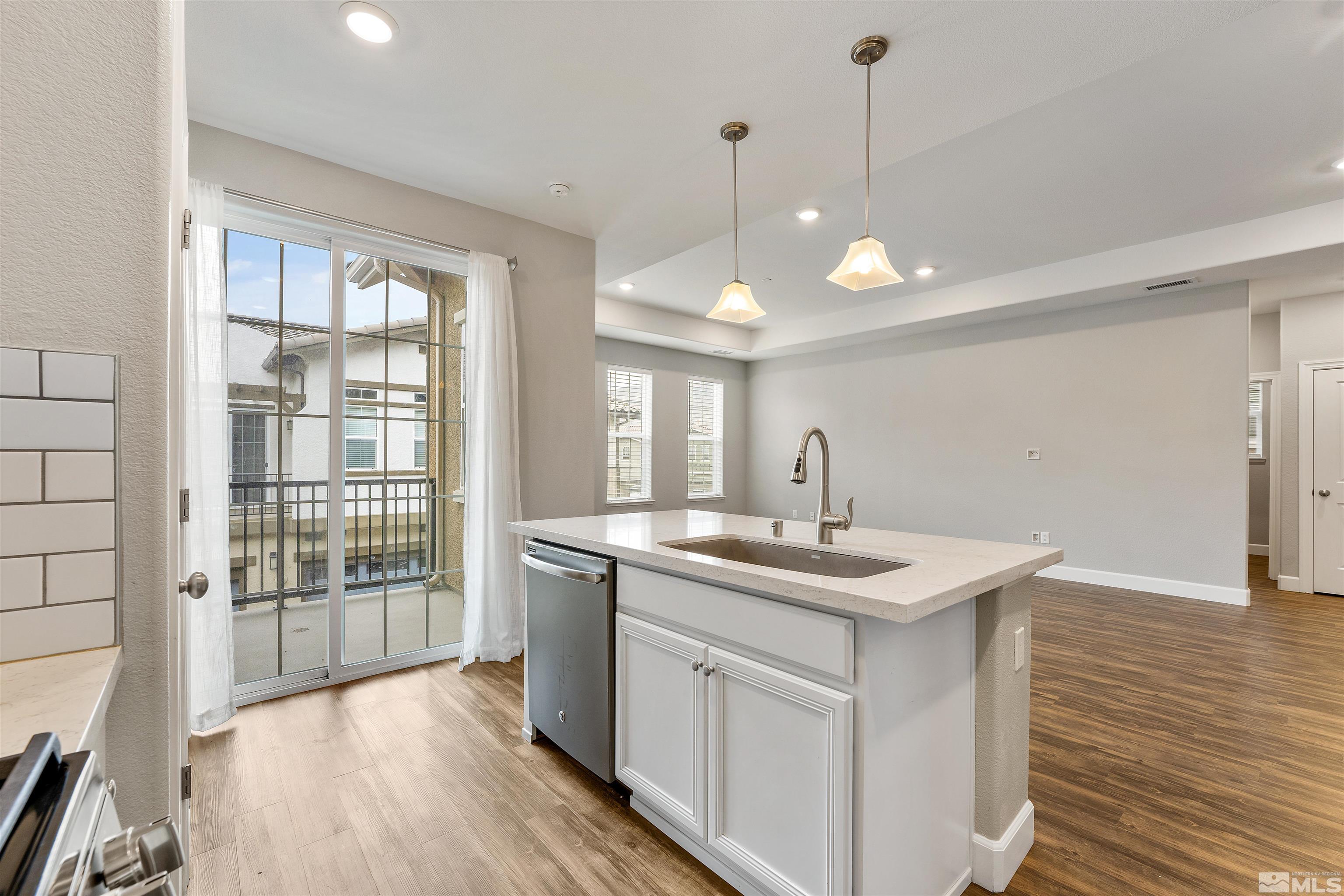 1945 Sea Horse Road, Unit A Reno, NV 89521 - Photo 12 of 25 a kitchen with a sink stove and wooden floor