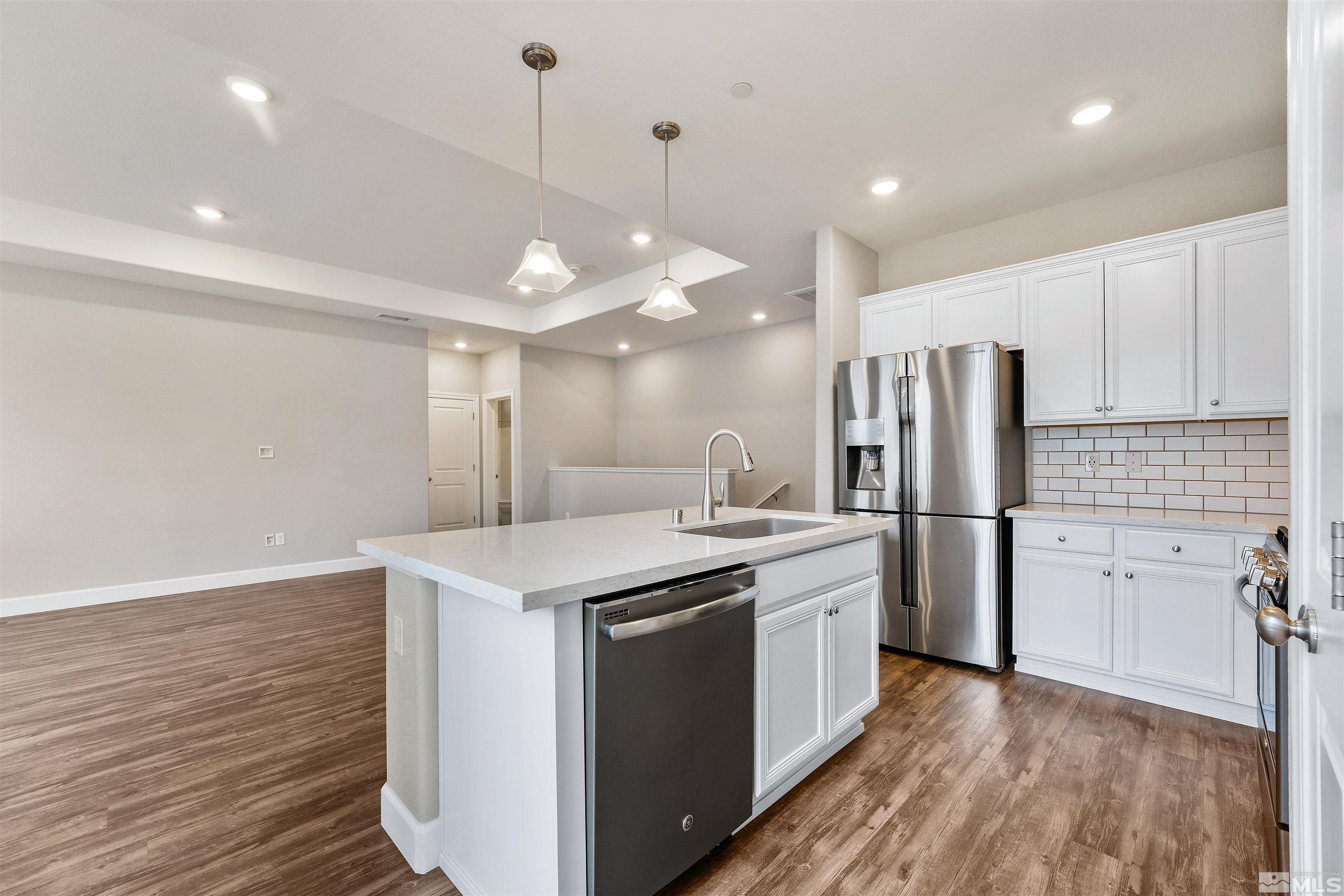 1945 Sea Horse Road, Unit A Reno, NV 89521 - Photo 13 of 25 a kitchen with refrigerator cabinets and wooden floor