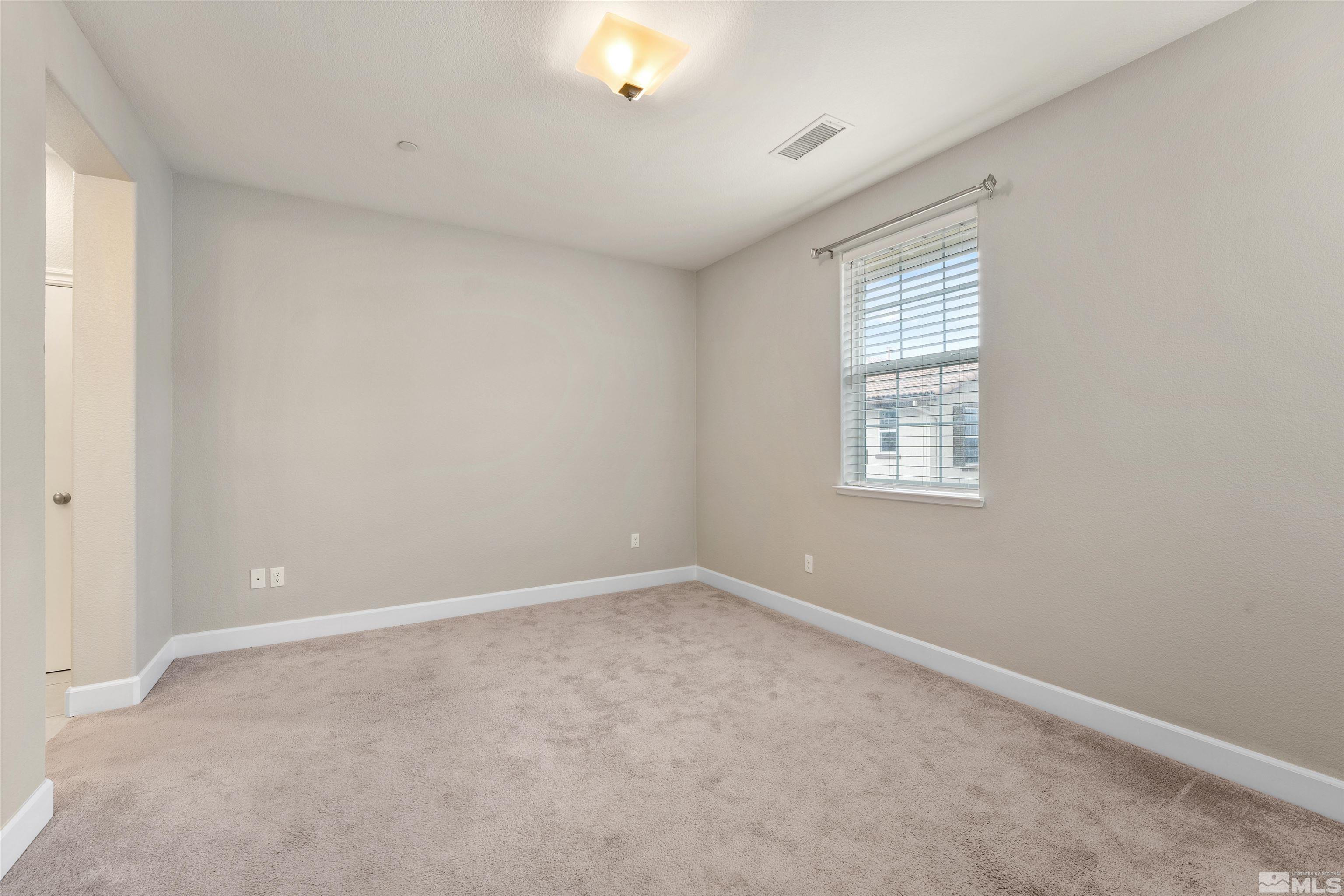 1945 Sea Horse Road, Unit A Reno, NV 89521 - Photo 15 of 25 an empty room with windows