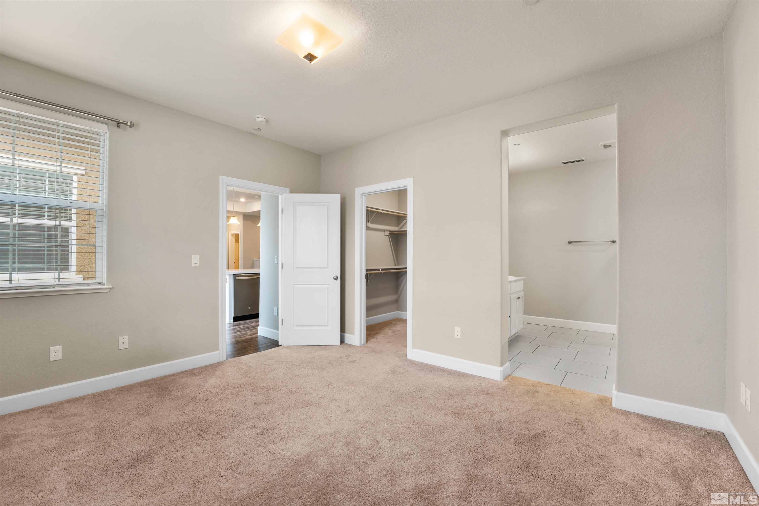 1945 Sea Horse Road, Unit A Reno, NV 89521 - Photo 16 of 25 an empty room with windows and closet