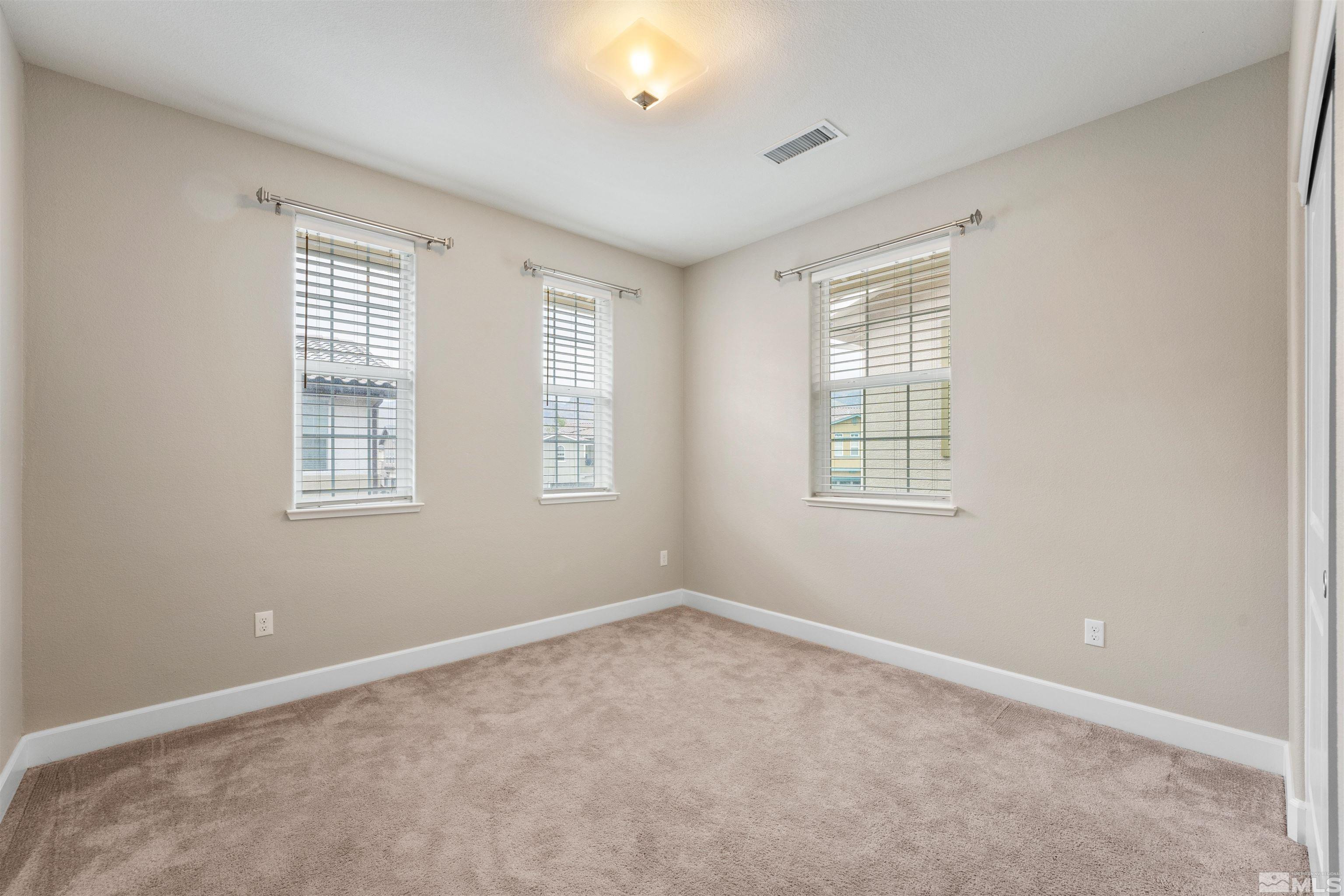 1945 Sea Horse Road, Unit A Reno, NV 89521 - Photo 18 of 25 an empty room with windows