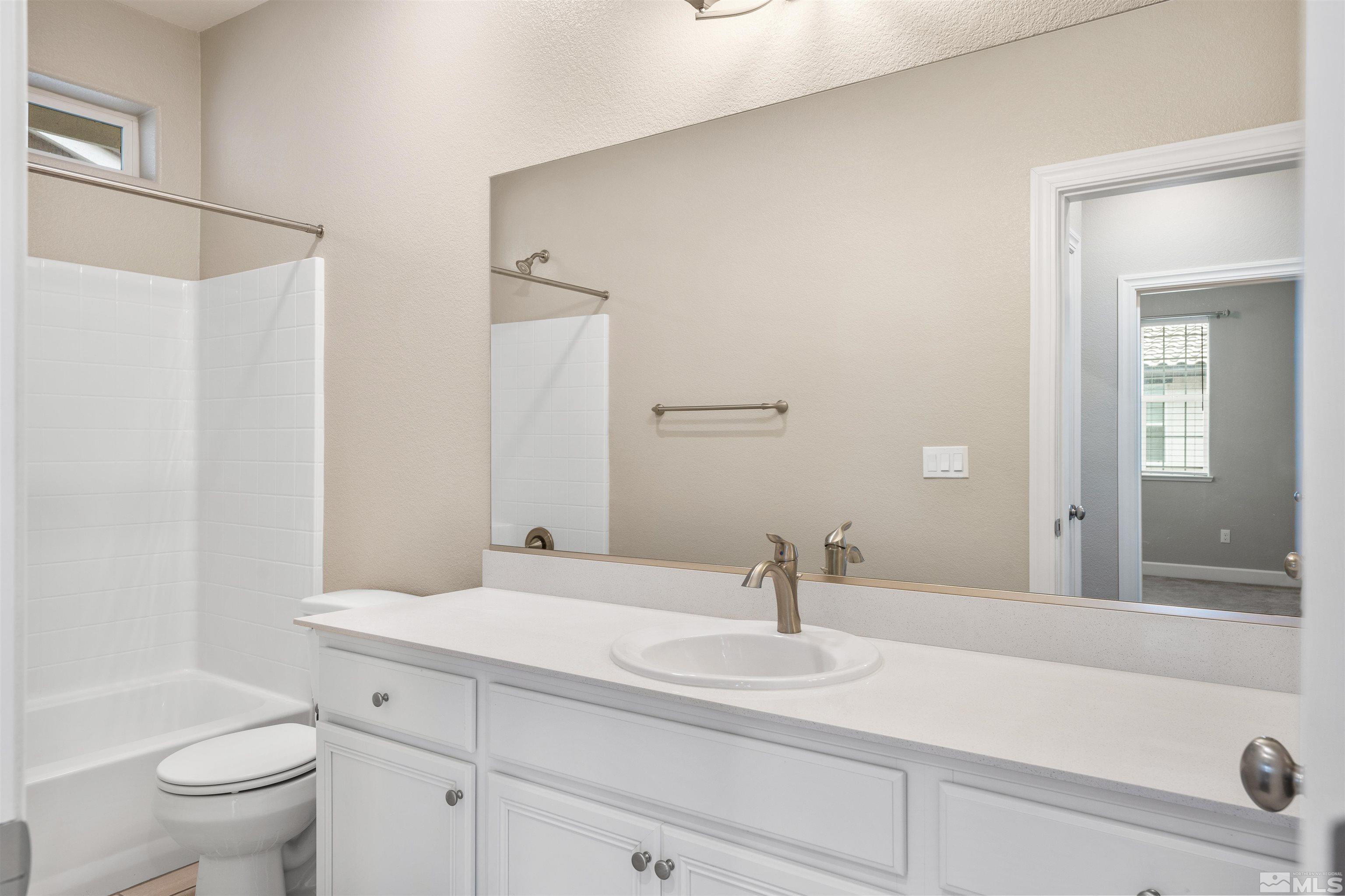 1945 Sea Horse Road, Unit A Reno, NV 89521 - Photo 20 of 25 a bathroom with a sink and a mirror