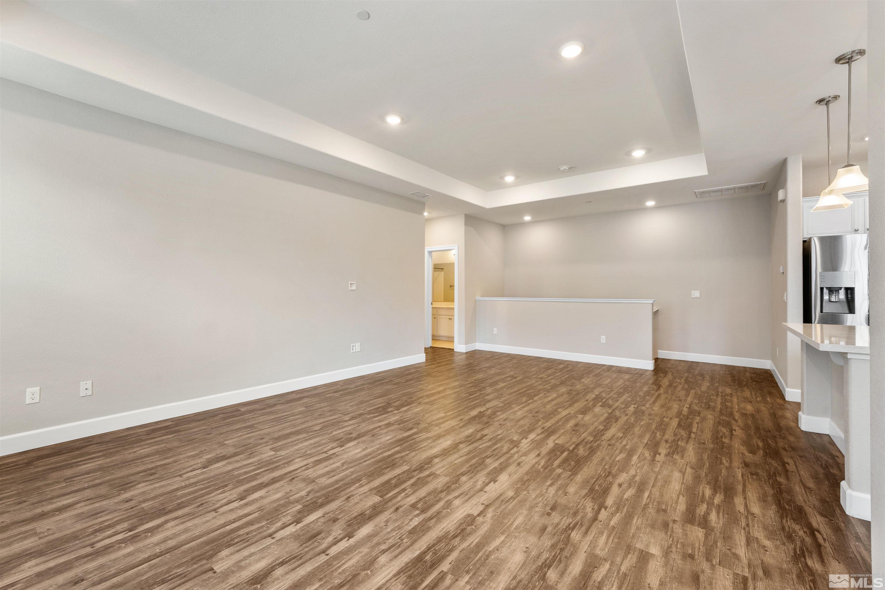 1945 Sea Horse Road, Unit A Reno, NV 89521 - Photo 7 of 25 a view of an empty room with wooden floor