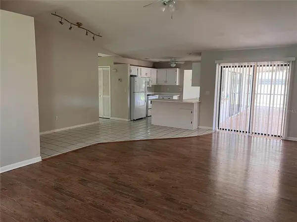 a view of a kitchen with wooden floor