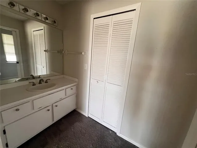 a bathroom with a double vanity sink and a mirror