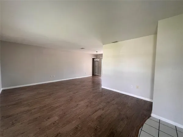 an empty room with wooden floor