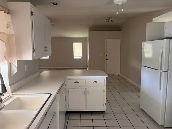 a kitchen with a sink and a refrigerator