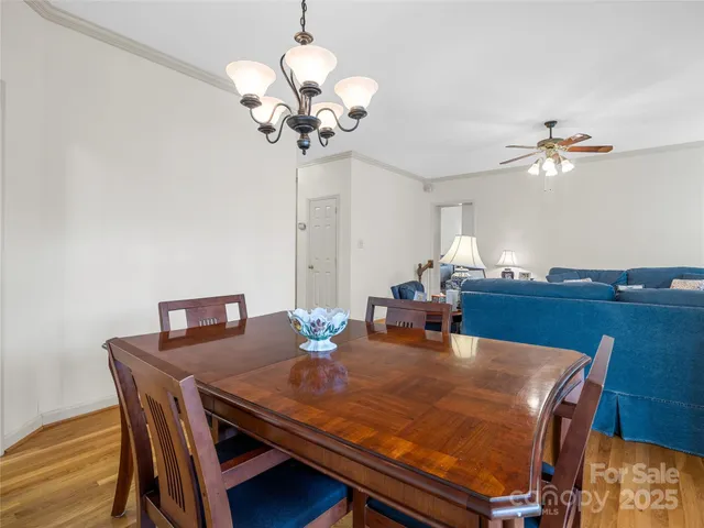 a view of a dining room with a table and chairs