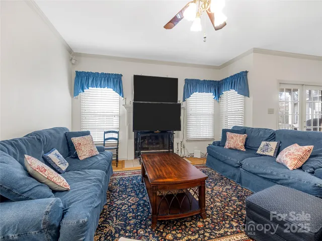 a living room with furniture fireplace and a window