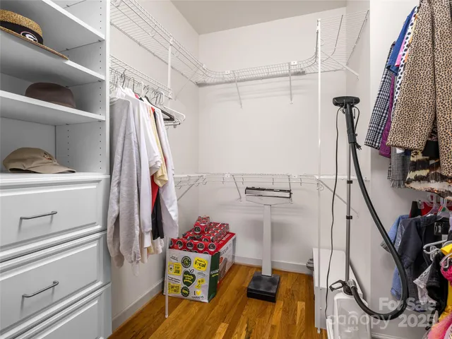 a view of walk in closet with clothes and shoes