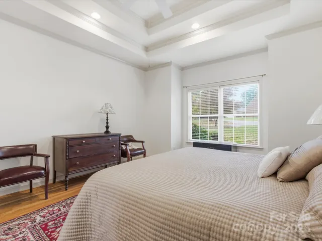 a bedroom with a bed a table and chair