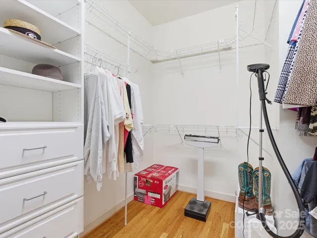 a view of walk in closet with clothes and shoes