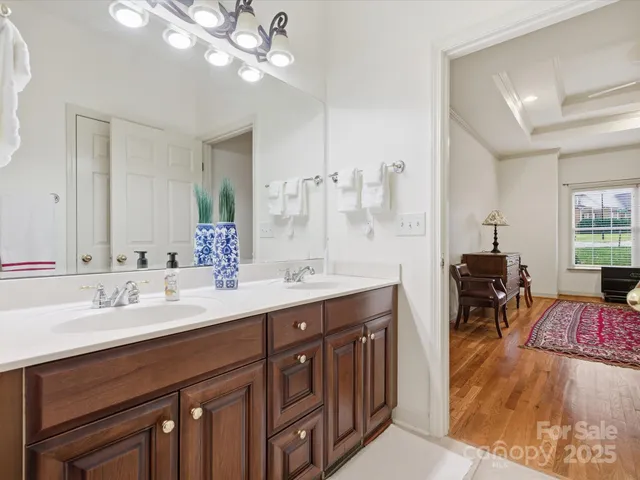 a spacious bathroom with a double vanity sink a mirror and shower