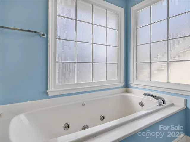a bath tub sitting next to a window
