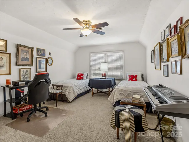 a bedroom with bed and a chandelier