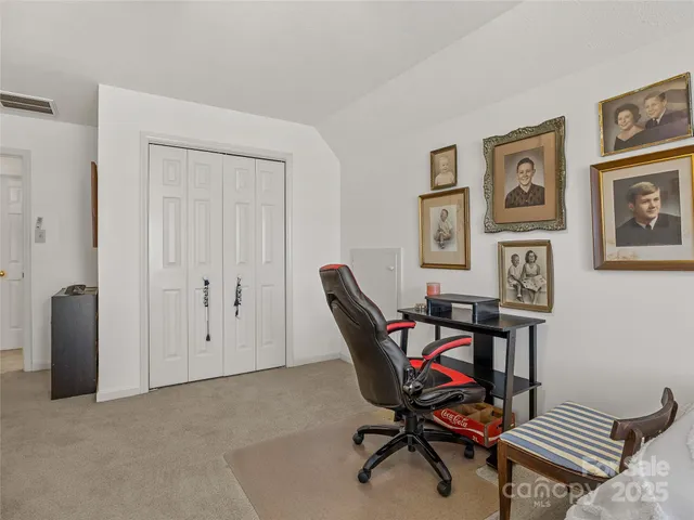 a work room with furniture and paintings on the wall