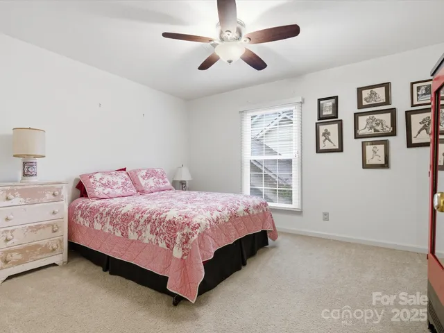 a spacious bedroom with a bed and a window