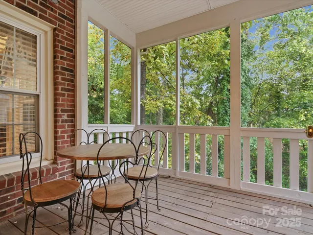 a view of a chairs and table in the balcony