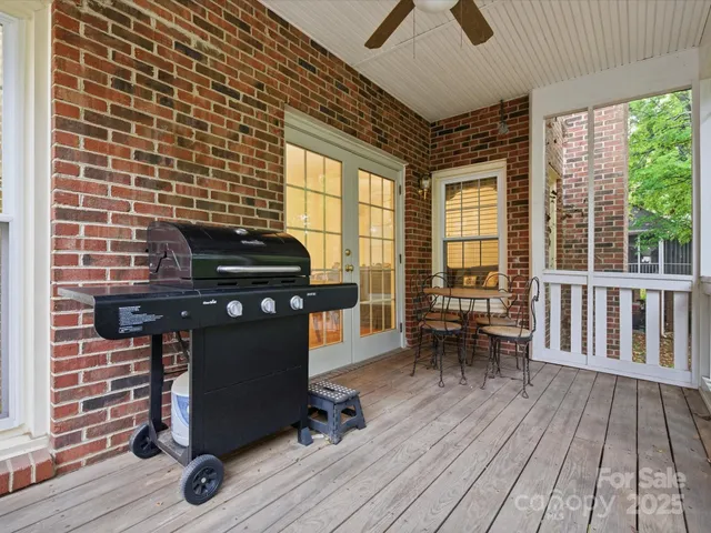 a view of a room with wooden floor and furniture