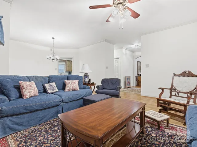 a living room with furniture a rug and a chandelier