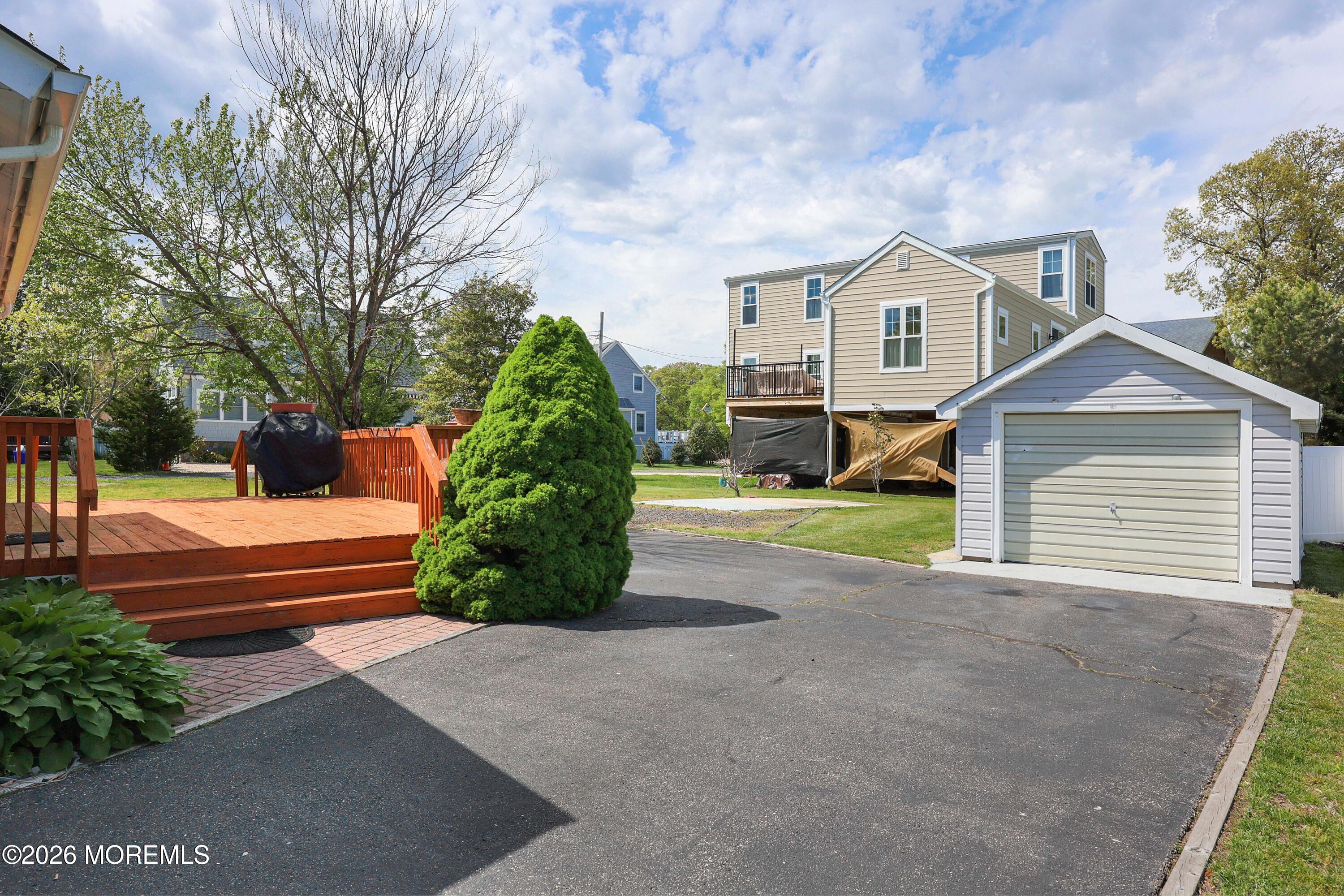 715 Howe Street Point Pleasant, NJ 08742 - Photo 23 of 45 a front view of a house with a yard and garage