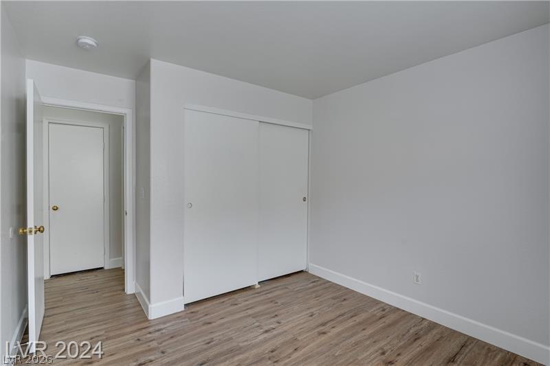 9660 Crystal Ridge Road Las Vegas, NV 89123 - Photo 18 of 18 A well-maintained bedroom offers ample storage with convenient sliding closet doors and durable flooring.