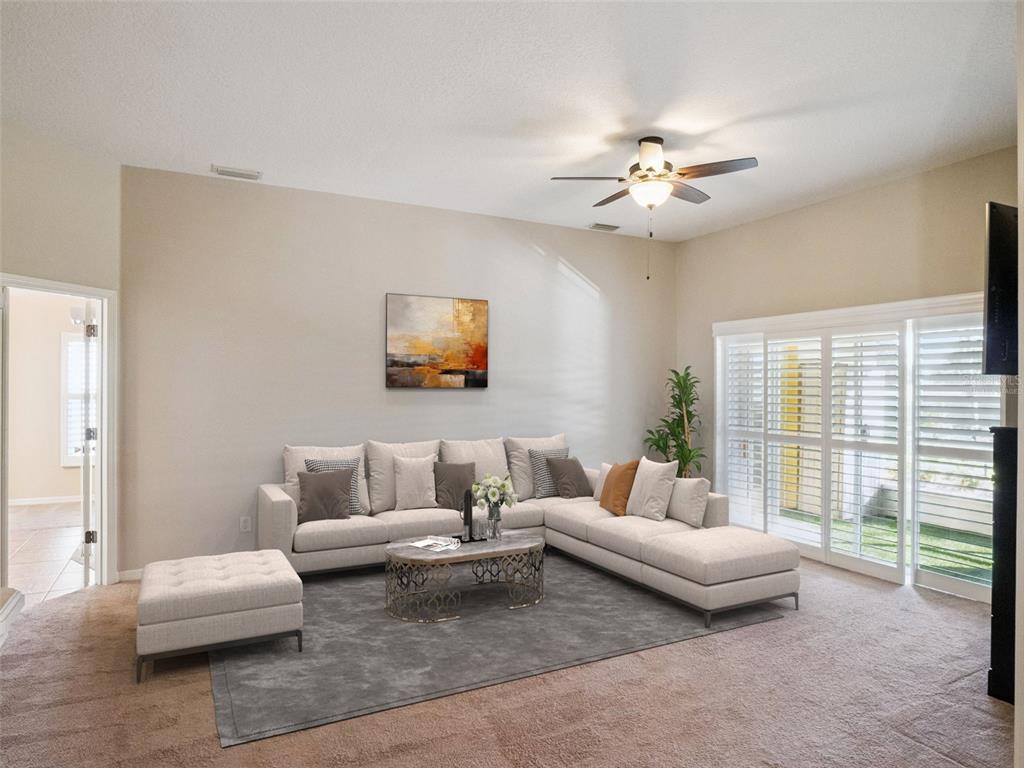 20642 Prince Ranier Place Leesburg, FL 34748 - Photo 12 of 59 a living room with furniture and a large window
