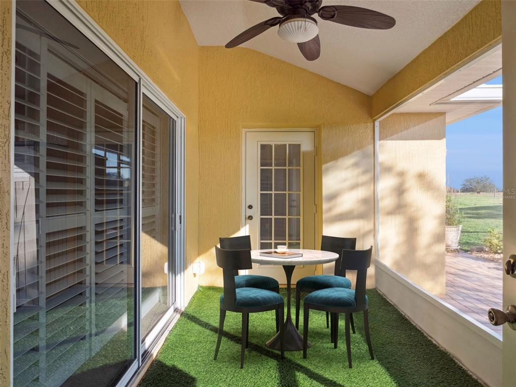 20642 Prince Ranier Place Leesburg, FL 34748 - Photo 18 of 59 a dining room with furniture and a floor to ceiling window