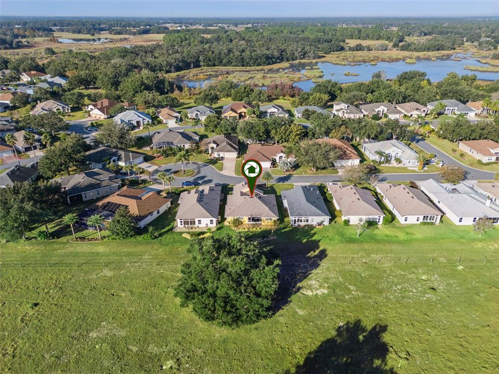 20642 Prince Ranier Place Leesburg, FL 34748 - Photo 27 of 59 an aerial view of residential houses with outdoor space and mountain view