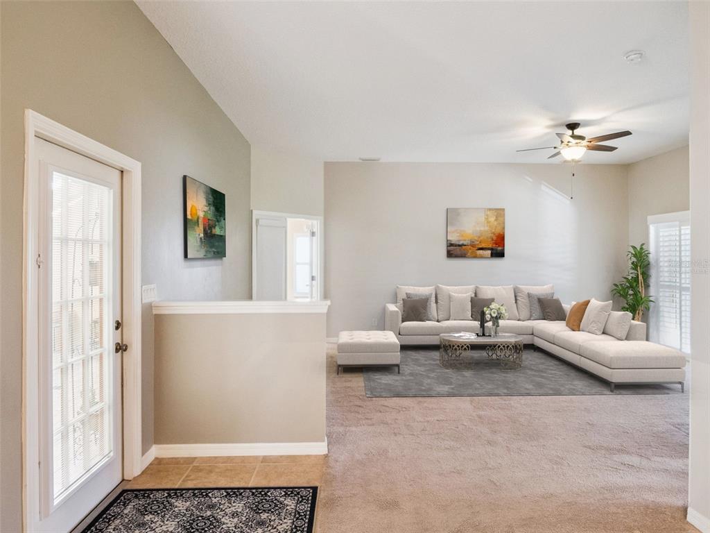20642 Prince Ranier Place Leesburg, FL 34748 - Photo 4 of 59 a living room with furniture and a window
