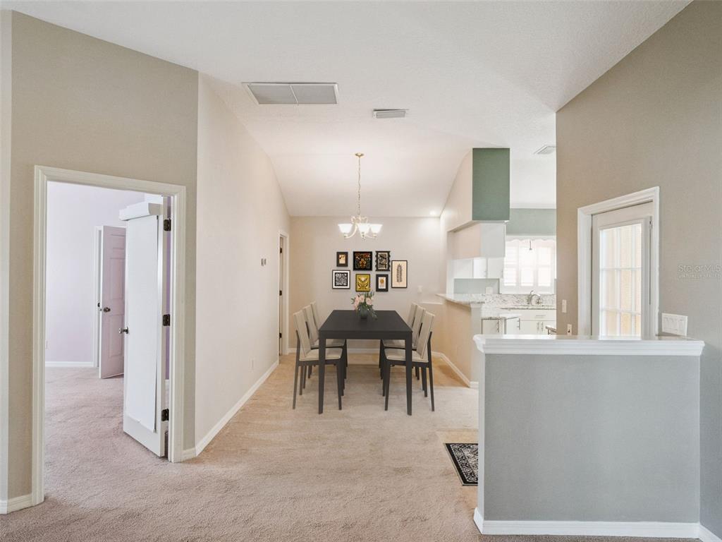 20642 Prince Ranier Place Leesburg, FL 34748 - Photo 5 of 59 a view of a livingroom with furniture window and a kitchen