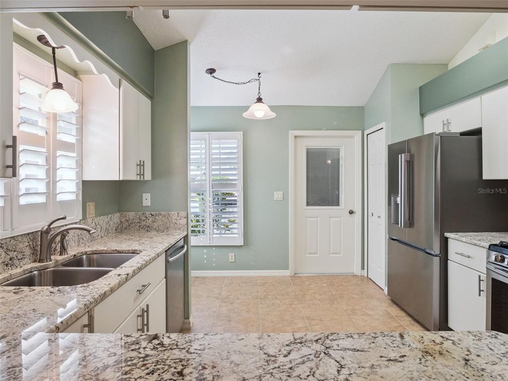 20642 Prince Ranier Place Leesburg, FL 34748 - Photo 8 of 59 a kitchen with a sink stove and refrigerator