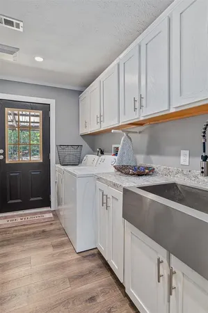 a kitchen with granite countertop a sink stainless steel appliances and cabinets
